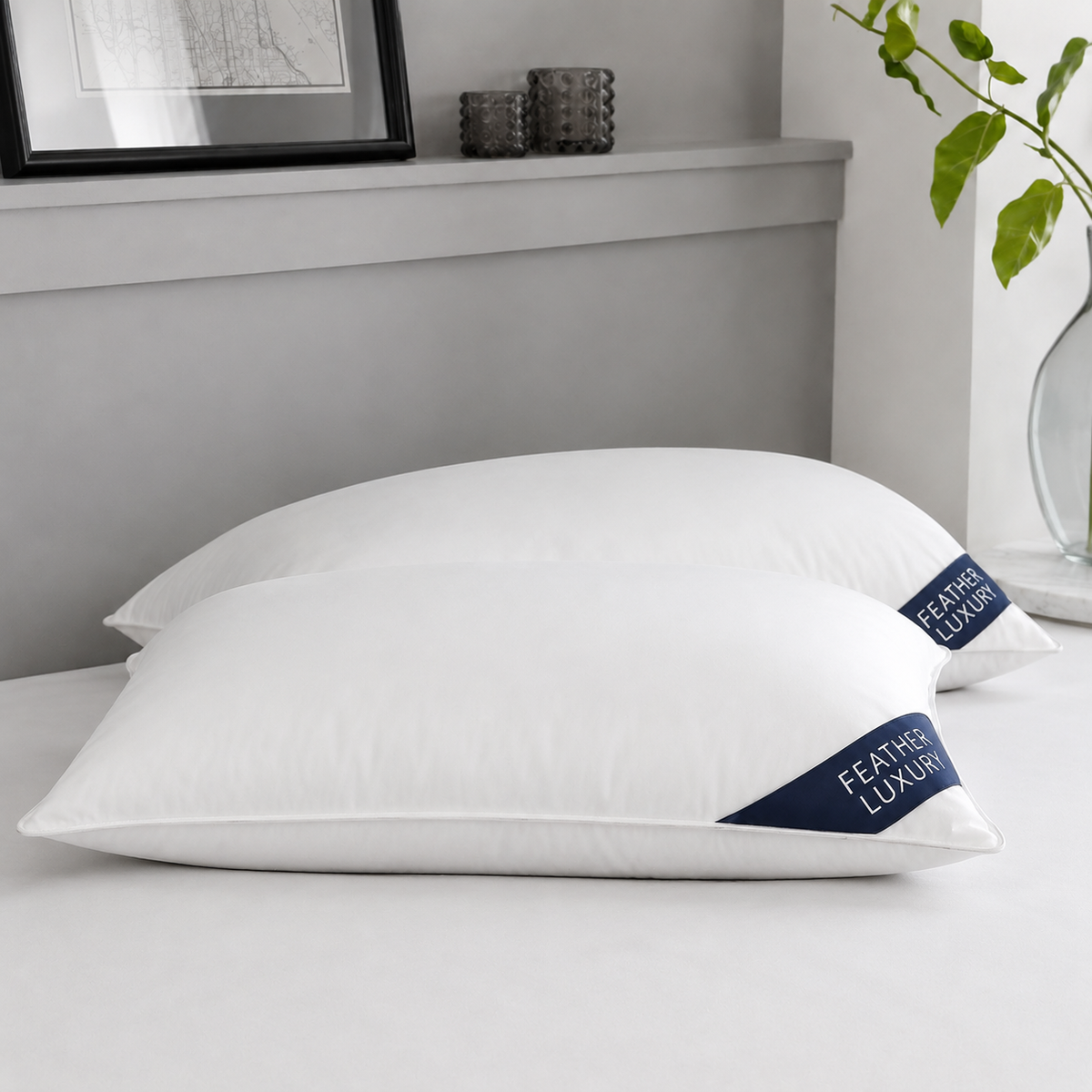 Duck feather pillow pair side view showing natural loft and navy badges