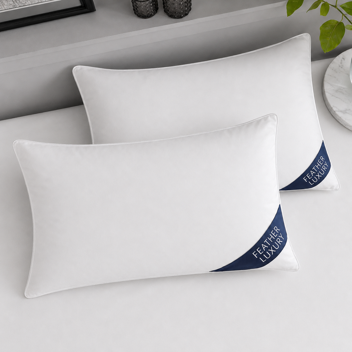Duck feather pillow pair top view with navy Feather Luxury badges