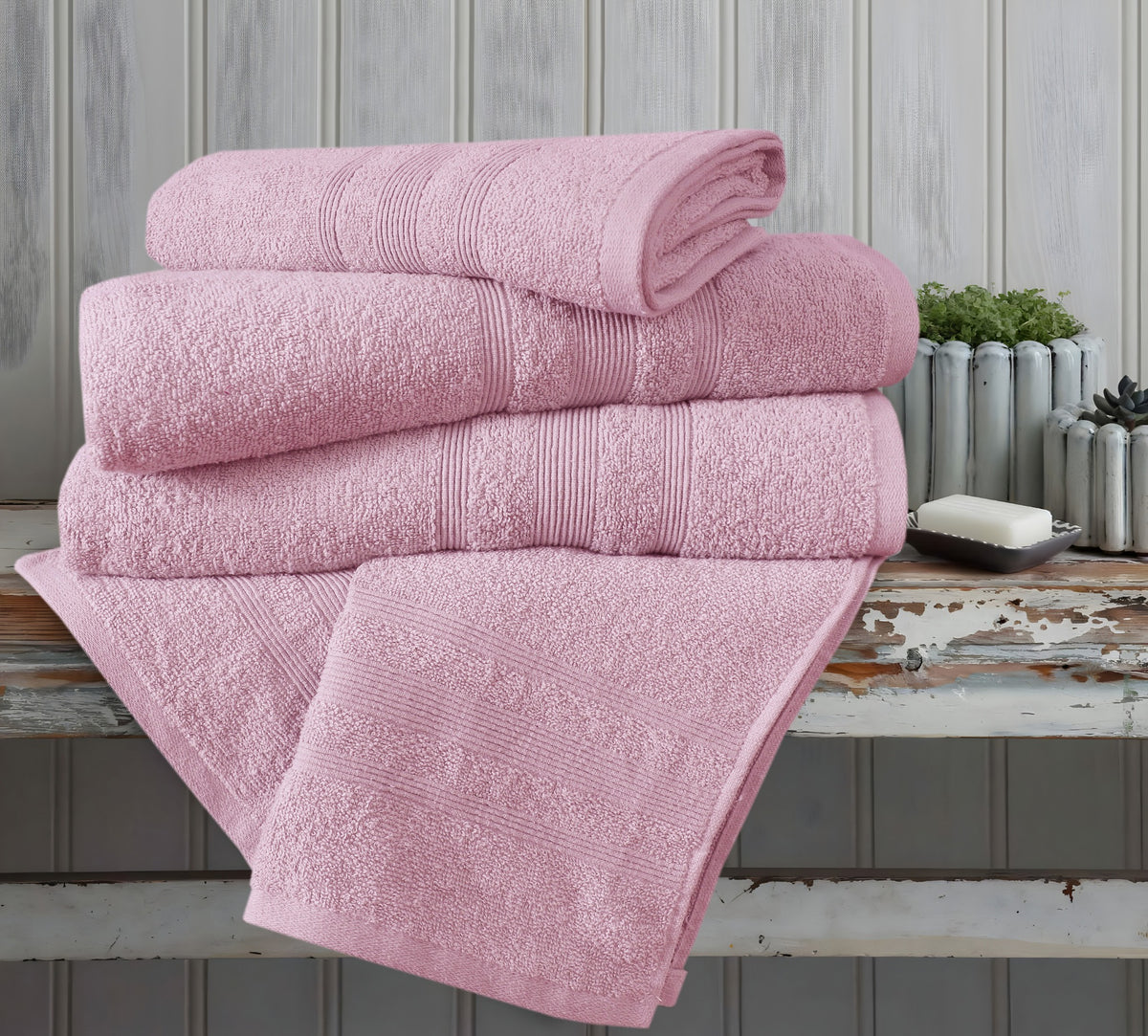 Pink cotton towels in bathroom setting