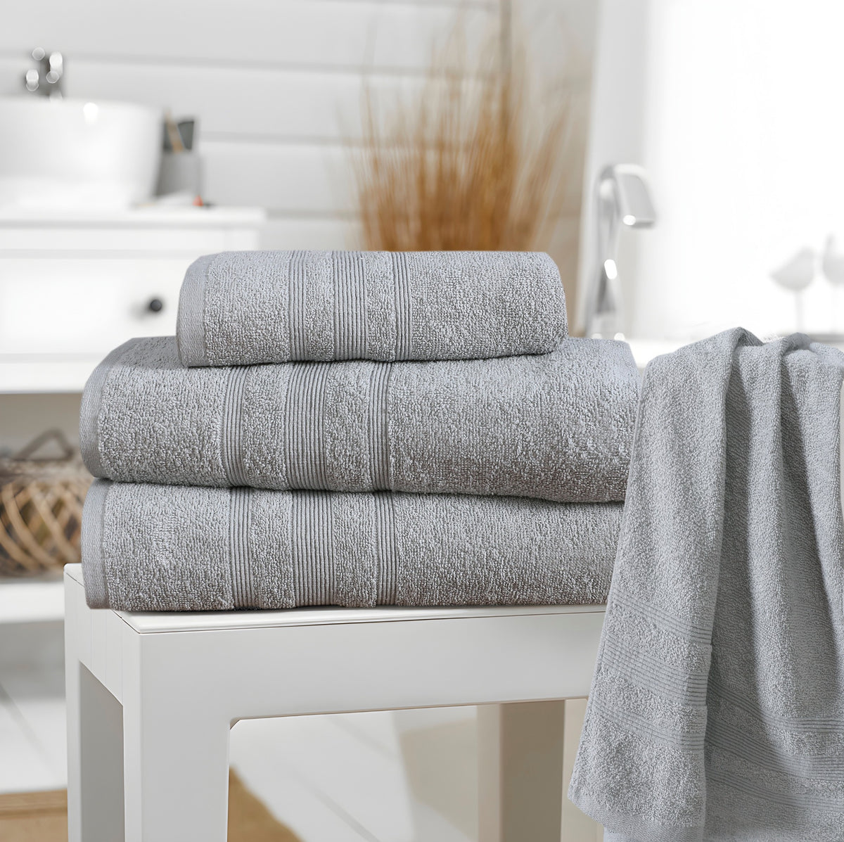 Silver grey cotton towels in bathroom setting