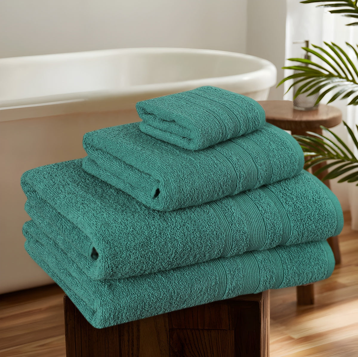Teal cotton towels in bathroom setting