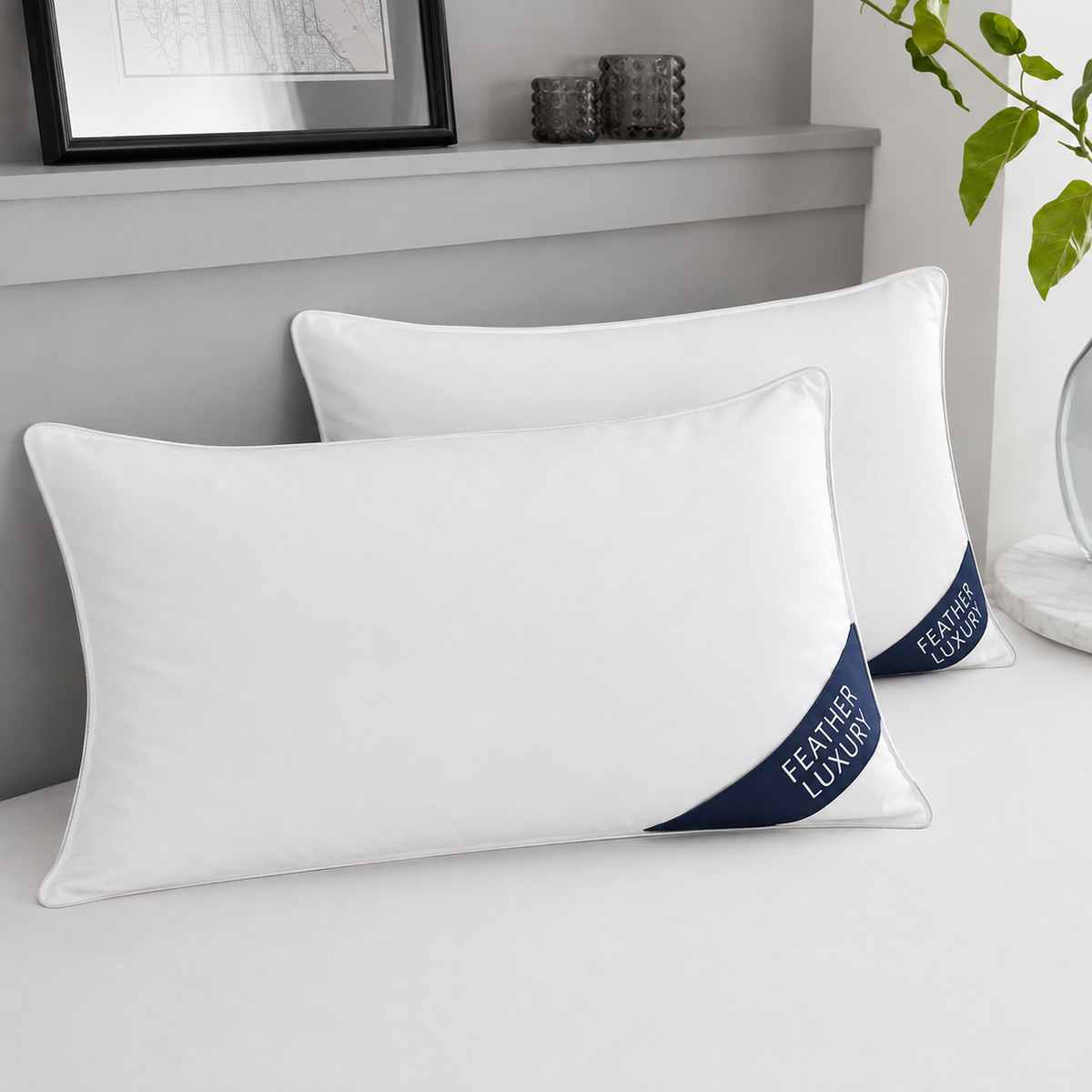 Pair of premium white duck feather pillows with navy Feather Luxury corner badges