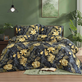 Aurelia black and gold tropical leaf duvet cover set on bed