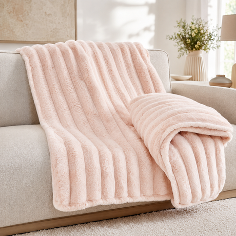 Blush Pink chunky ribbed plush blanket throw on a sofa