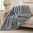 Grey chunky ribbed plush blanket throw on a sofa