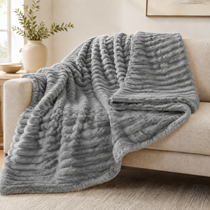 Grey chunky ribbed plush blanket throw on a sofa
