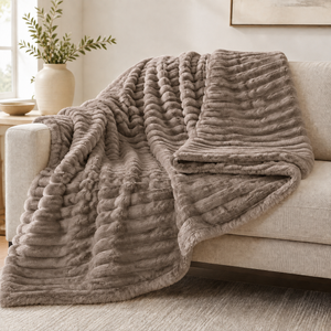 Mink chunky ribbed plush blanket throw on a sofa