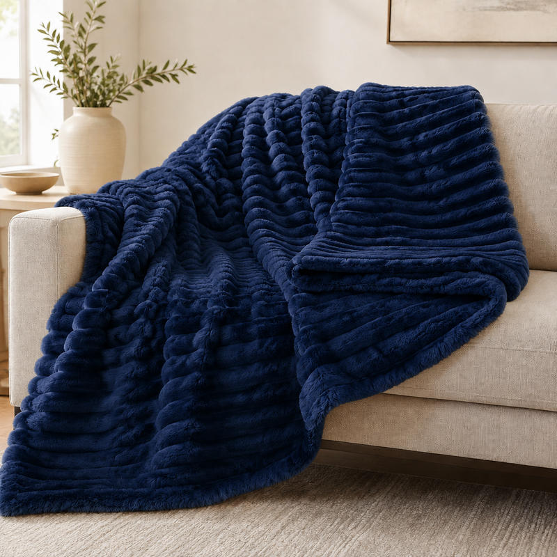 Navy chunky ribbed plush blanket throw on a sofa