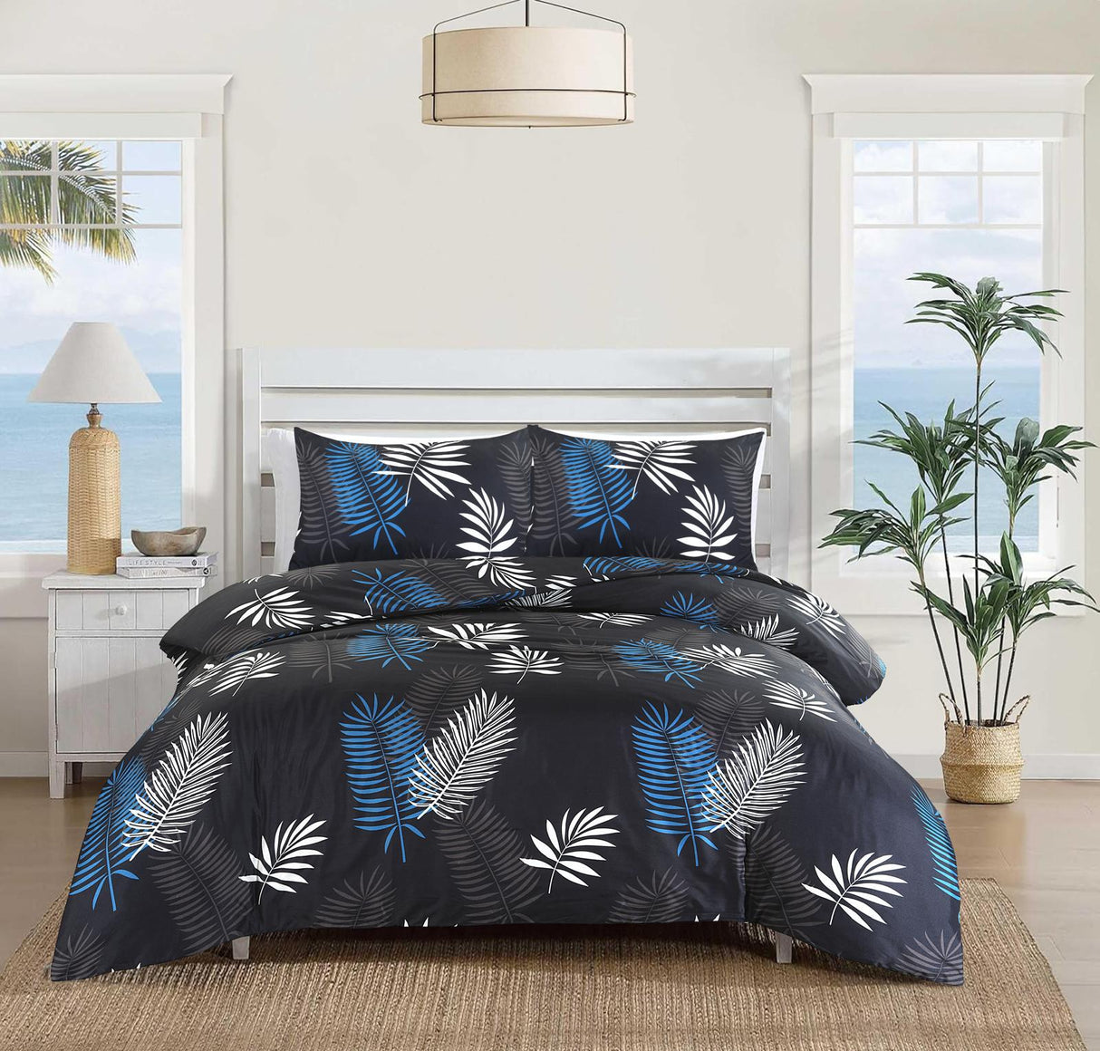 Mystic black blue and white palm leaf duvet cover set on bed