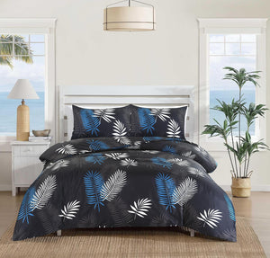 Mystic black blue and white palm leaf duvet cover set on bed