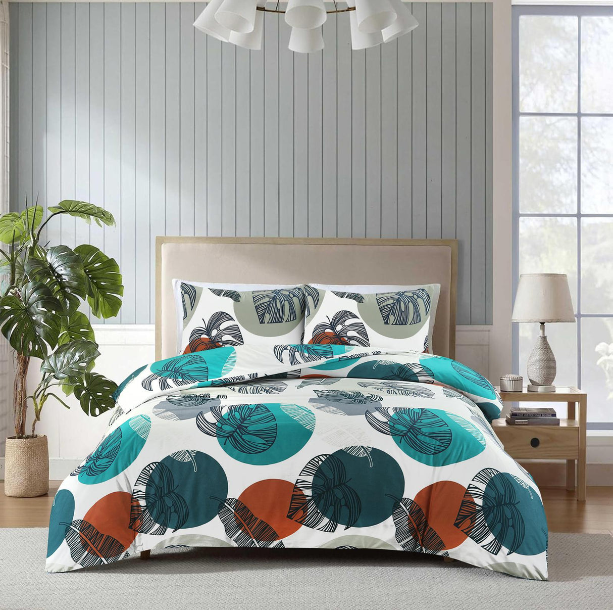 Oasis teal rust and white abstract leaf duvet cover set on bed